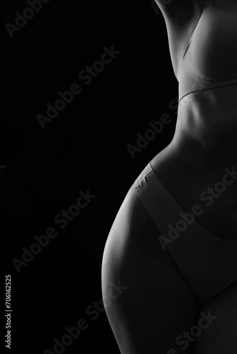 Silhouette of attractive young woman in underwear on dark background  closeup