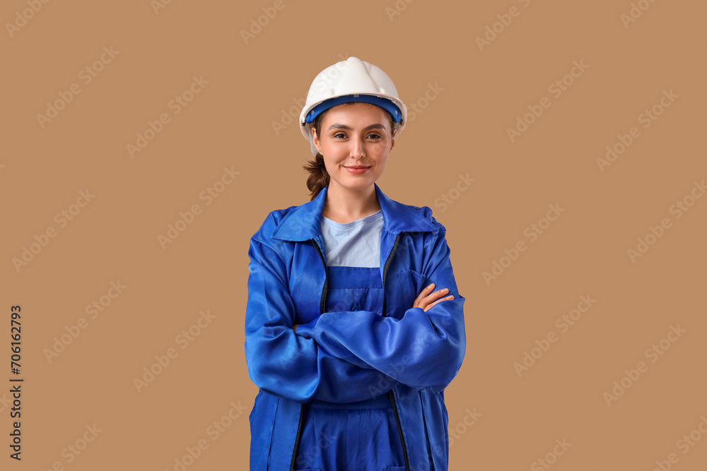Female worker in uniform on brown background