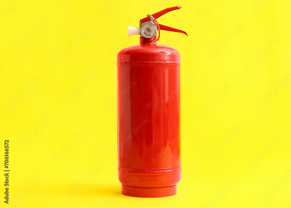 Fire extinguisher on yellow background