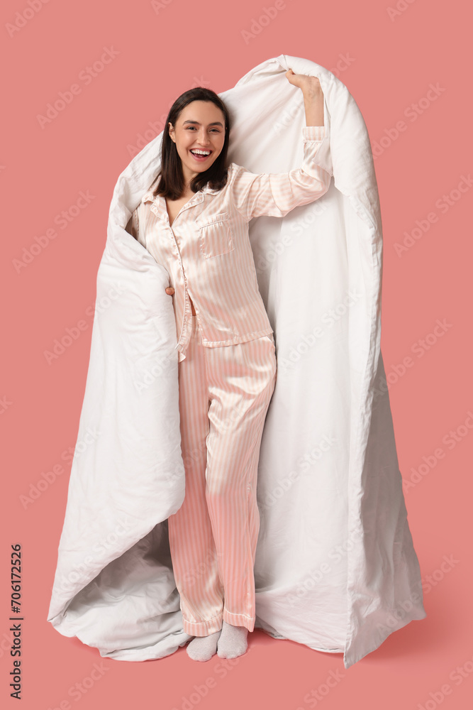 Pretty young woman with blanket on pink background Pretty young woman with blanket on pink background