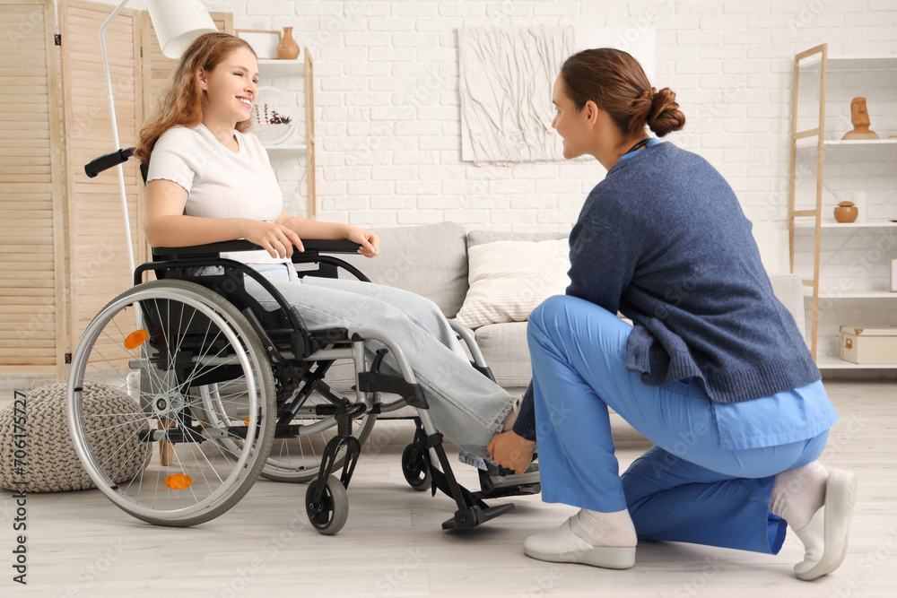 Young redhead woman in wheelchair with nurse at home Young redhead woman in wheelchair with nurse at home