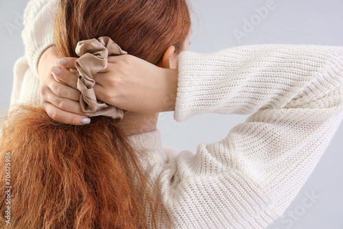 Young redhead woman making ...