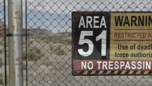 High quality 3D CGI render of a chainlink fence at a secret military installation in a desert scene, with an Area 51 Warning Restricted Area sign, photo