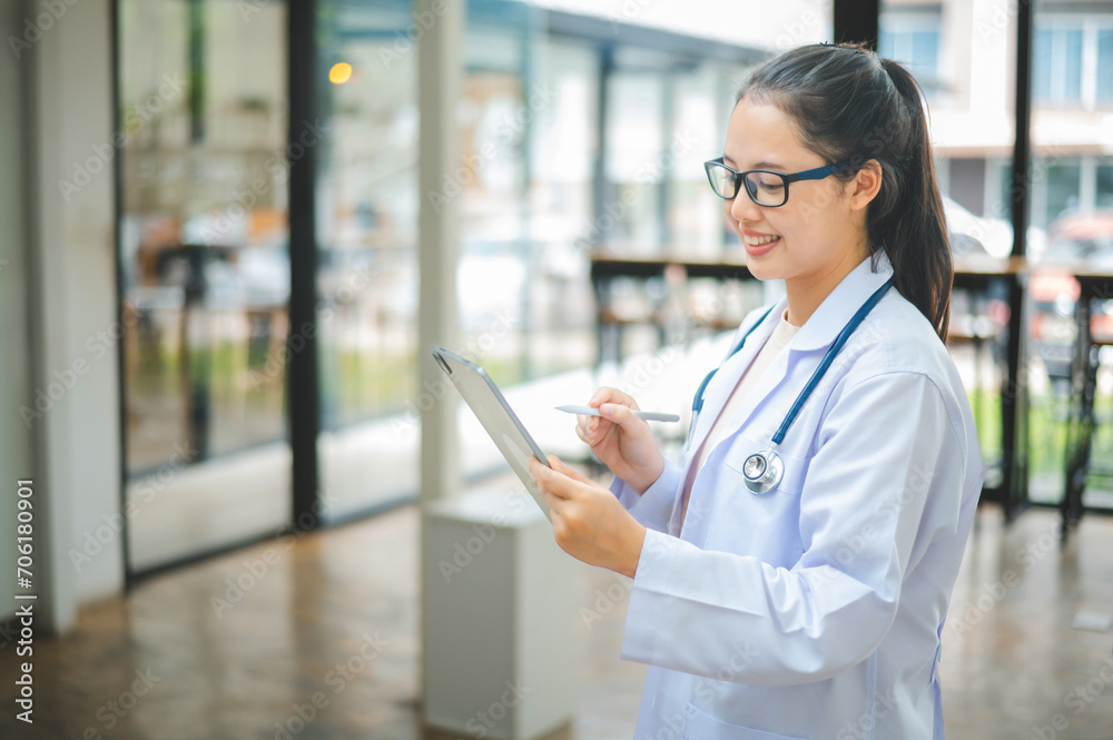 Portrait doctor with a stethoscope and using digital tablet stands confidently ready for healthcare visitor in hospital or clinic. Portrait doctor with a stethoscope and using digital tablet stands confidently ready for healthcare visitor in hospital or clinic.