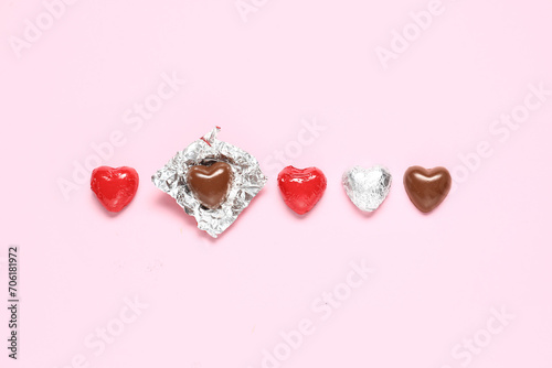 Tasty heart-shaped chocolate candies on pink background. Valentine's Day celebration