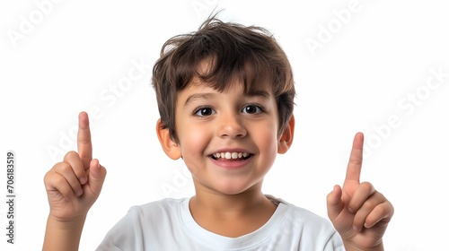Portrait of a cute little boy pointing up on white background.