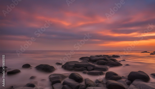 Golden hour sunset. Orange sunset at seaside with rocks