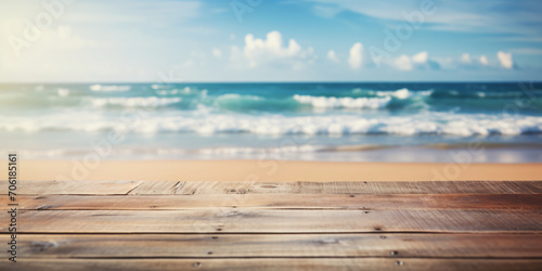 Empty wooden table with serene seascape background, calm ocean, and blurry sky at the beach. For product display editing, concept of relaxing, Summer holiday.