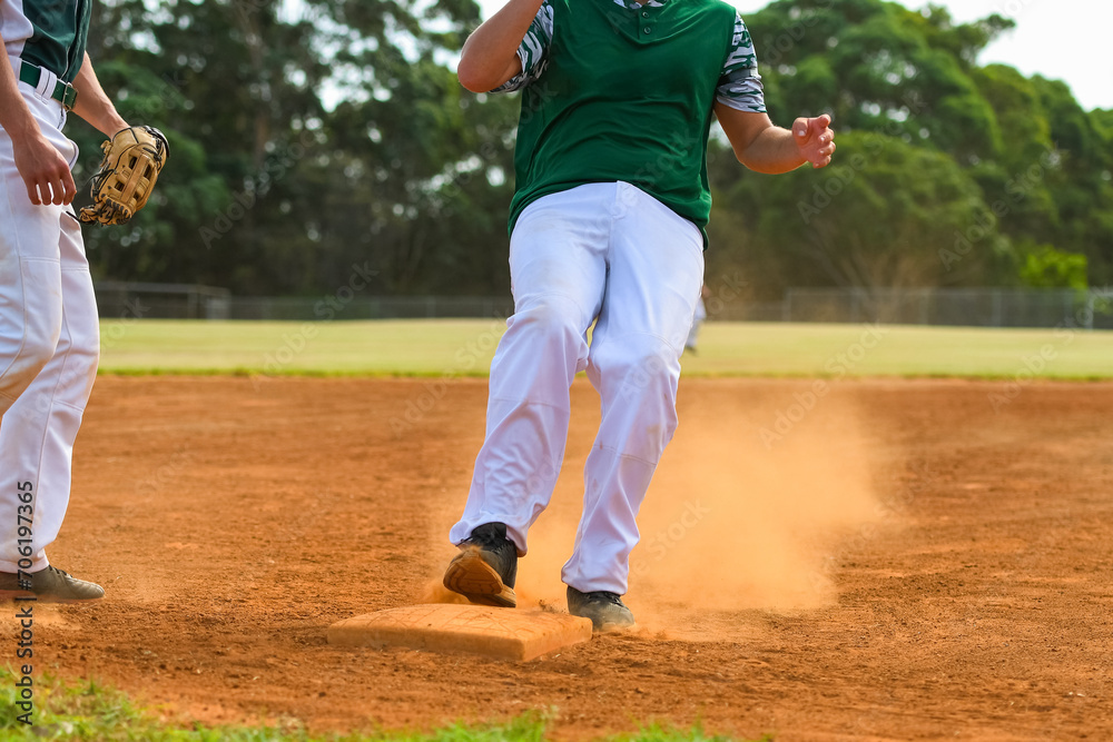 Baseball game, running bases. Runner steals the third base during the ball game Baseball game, running bases. Runner steals the third base during the ball game