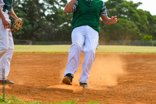 Baseball game, running bases. Runner steals the third base during the ball game