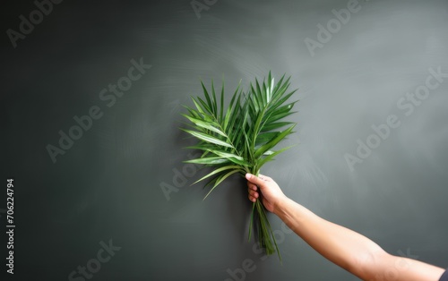 Hand holding palm leaf with copy space. Palm Sunday celebration. Generative AI photo