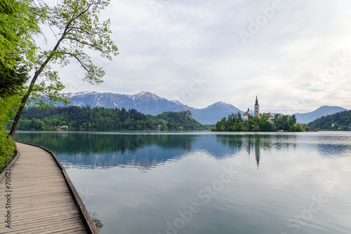 spring landscape of the Bled lake in Slovenia with wooden pier in cloudy weather 
