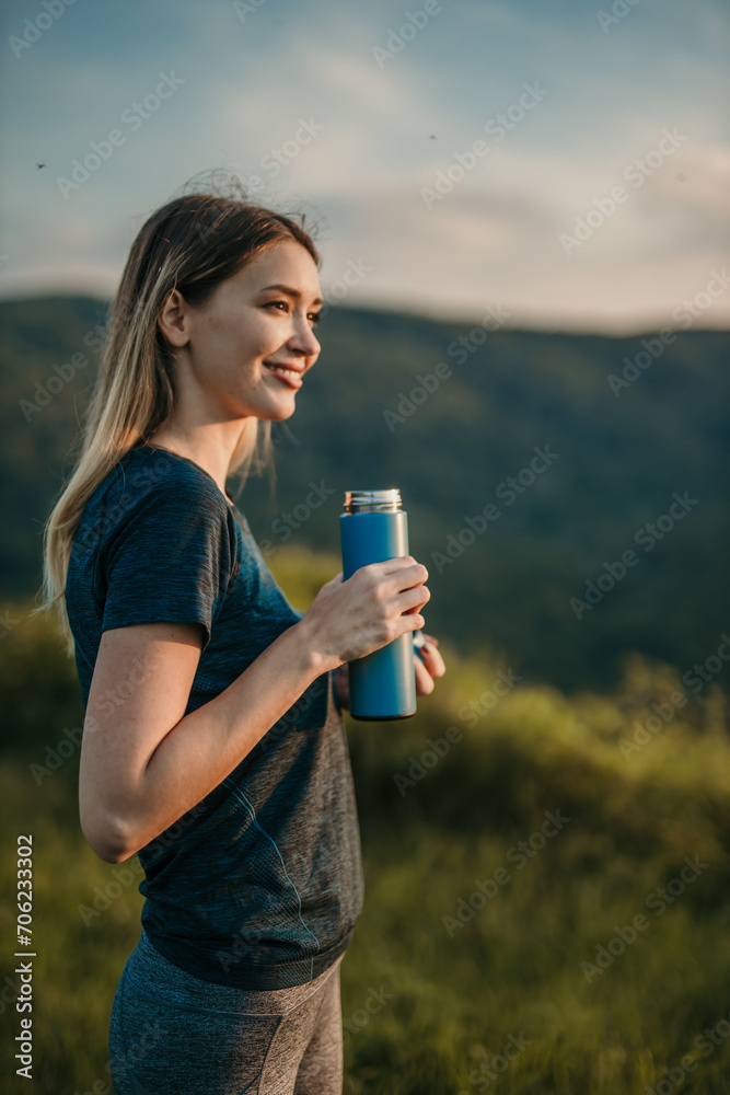 Fit Caucasian woman quenching her thirst with refreshing water after a vigorous outdoor jog Fit Caucasian woman quenching her thirst with refreshing water after a vigorous outdoor jog