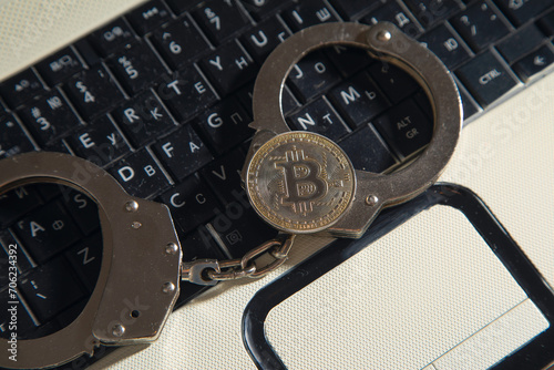 Golden bitcoin and handcuffs. Virtual currency