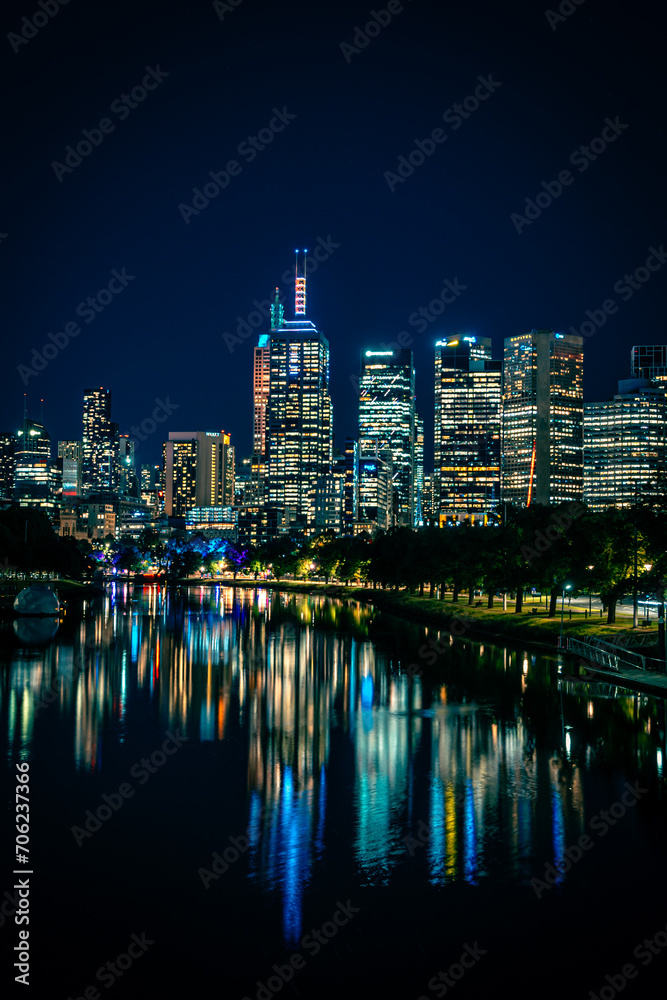 Illuminated downtown city buildings at night in Melbourne, Australia.