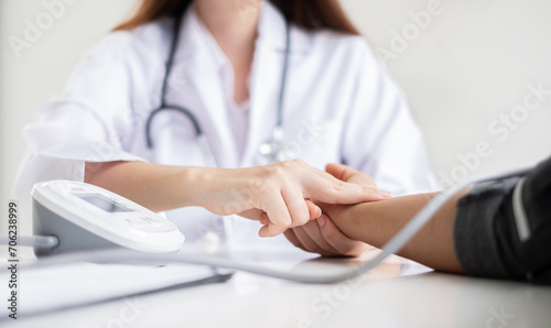 The female doctor measured blood pressure, the patient examined the heartbeat and sat down to talk about health care closely. health care concept
