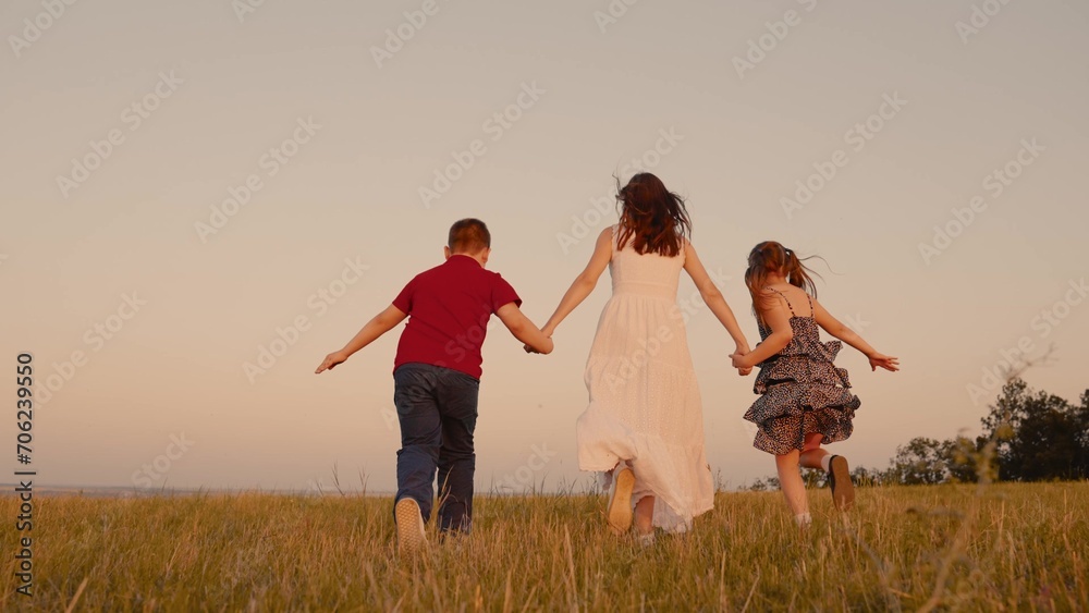 mother runs into sunset mother runs into sunset holding her son daughter hand, happy family running, boy girl, children dreams running, join us this adventure, happy kids running playing together wind