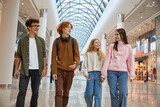 Group of young friends shopping at big city store center