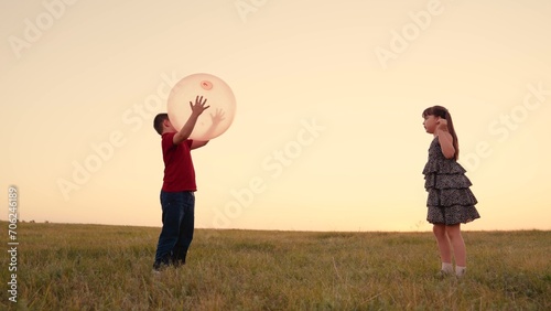 Girl Child Boy Kid playing big ball sunset, children dream flying, happy family, we are joyful, team, small group friends standing field, small team journey happiness, game filled with pure excitement