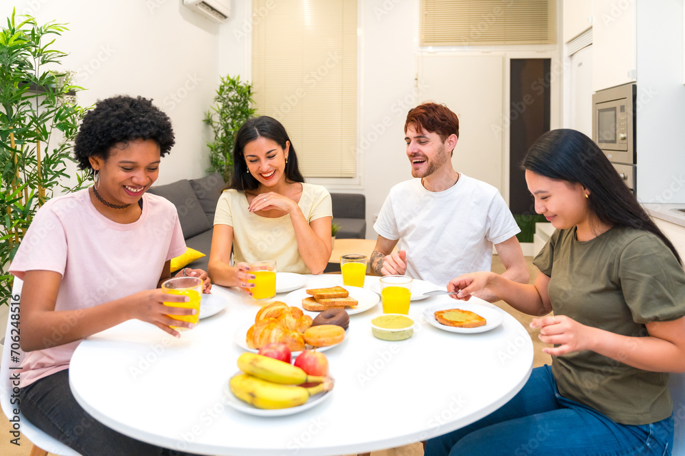 Happy friends having a healthy breakfast together at the apartment Happy friends having a healthy breakfast together at the apartment