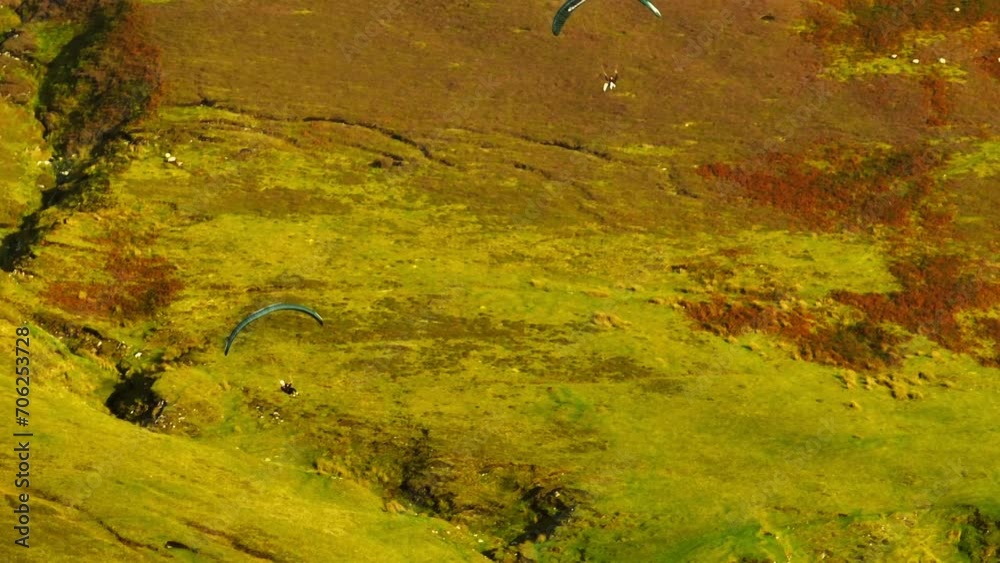Two paragliders cruising along cliffs of Keel beach, Achill Island. Aerial Two paragliders cruising along cliffs of Keel beach, Achill Island. Aerial