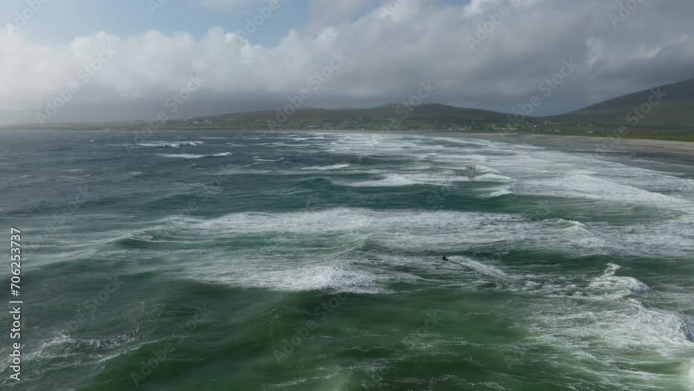 Kitesurfer braves tumultuous ocean at Keel Beach, Achill Island. Drone Kitesurfer braves tumultuous ocean at Keel Beach, Achill Island. Drone