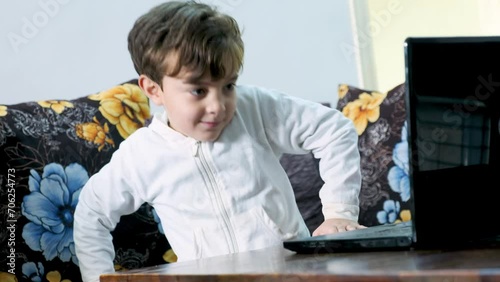 Boy interacting while using laptop  photo