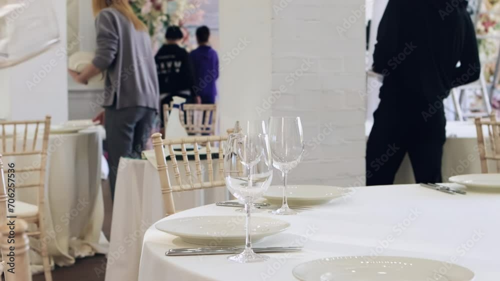 waiters lay out cutlery on the table, preparing for the wedding banquet, the staff lays out plates and bakals, cutlery waiters lay out cutlery on the table, preparing for the wedding banquet, the staff lays out plates and bakals, cutlery