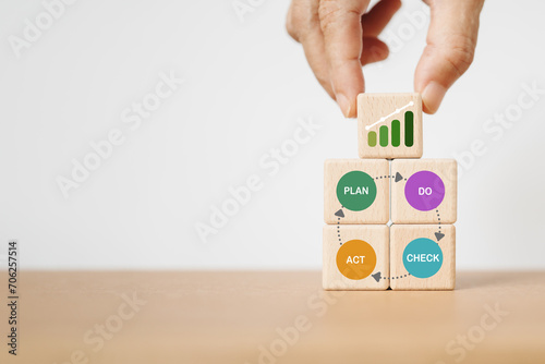 Continuous quality improvement model of 4 keys stages ( Plan, Do, Check, Action or PDCA), efficiency concept. Solving problems, improving organizational process. Hand arranged wooden cube block