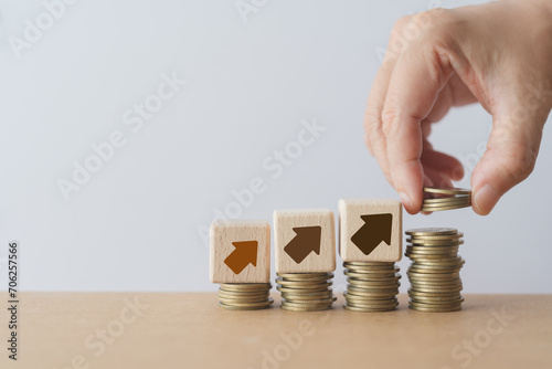 cash management for saving or investment, fund, RMF, LTF concept. Hand add money coin   stacking and up arrow icon on wooden cube blocks. Copy space included