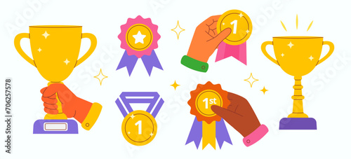 Hands holding Winner golden cups, medals, badges set vector illustration 