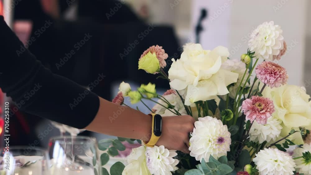 a woman decorates a banquet hall with flowers, a girl decorates a wedding hall a woman decorates a banquet hall with flowers, a girl decorates a wedding hall