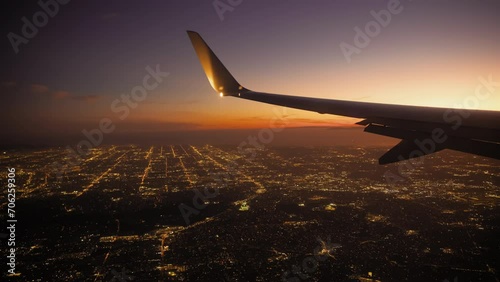 Airplane Jet plane prepare to landing in Los Angeles LAX airport. Porthole view with wing. Slow motion