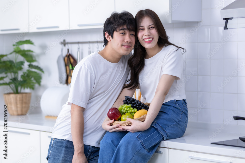 Happy Family portrait of loving young asian of having fun standing a cheerful preparing food and enjoy cook cooking with vegetables, meat, bread while standing on a kitchen Condo life or home