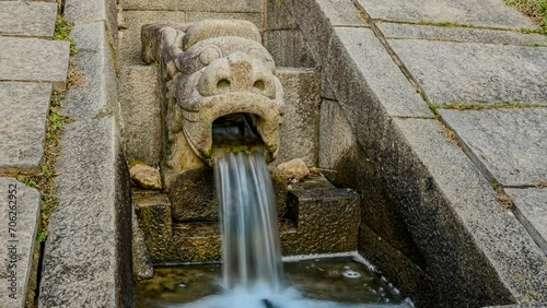 Time lapse, water flowing through the mouth of a centuries-old statue in Hwaseong, Suwon.