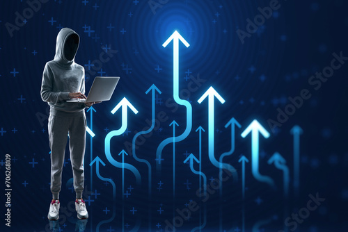 Hacker in hoodie using laptop with growing blue business chart arrows on blurry backdrop. Success, hacking, trend and financial growth concept.