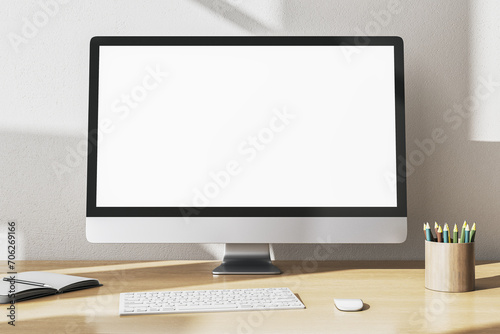 Modern designer office desktop with empty white mock up computer monitor, supplies and other items. 3D Rendering. photo