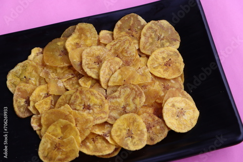 Banana chips on a black background, banana chips for Onam festival, traditional South Indian tea time snack