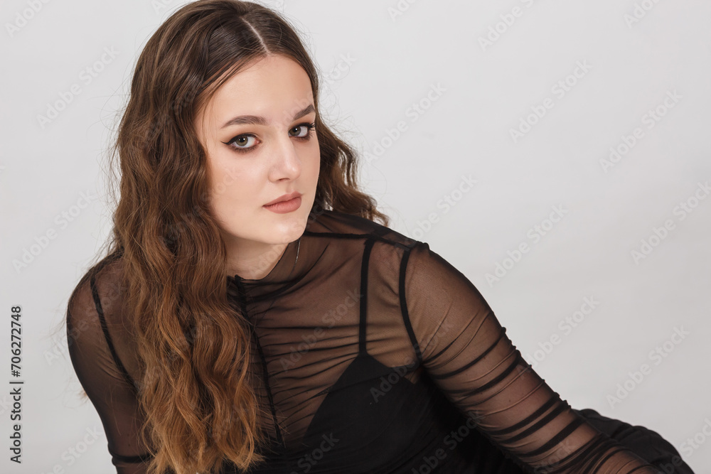 Fototapeta premium girl model in black shirt trousers posing relaxed in studio on white background