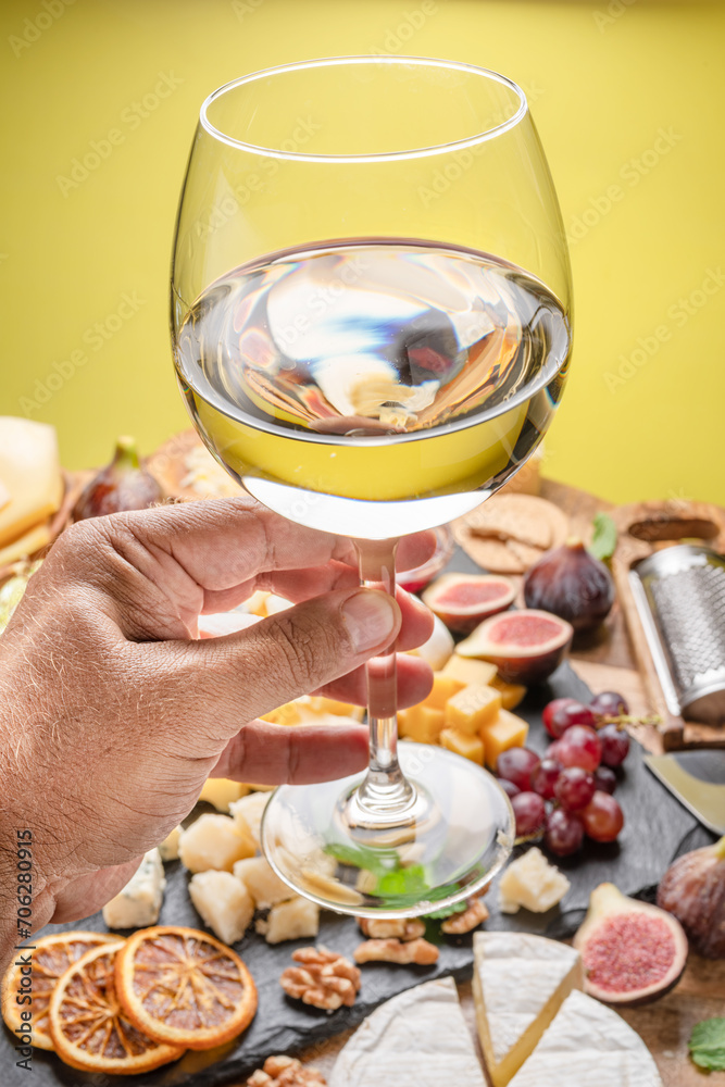Glass of white wine in a man's hand. Glass of white wine in a man's hand.