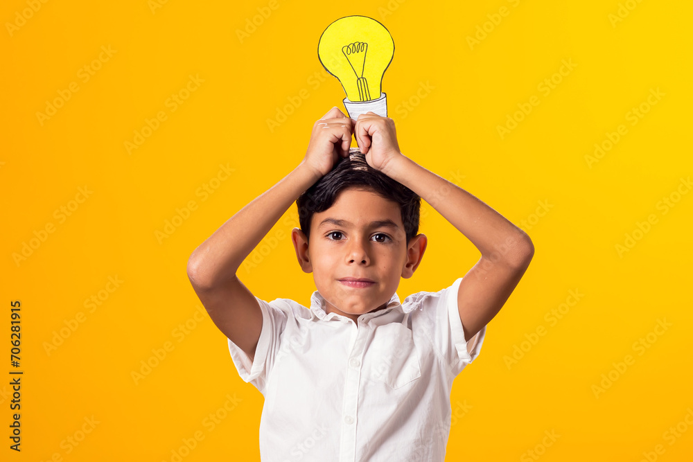 Child boy holding paper bulb. Success, motivation, winner, genius, idea concept Child boy holding paper bulb. Success, motivation, winner, genius, idea concept
