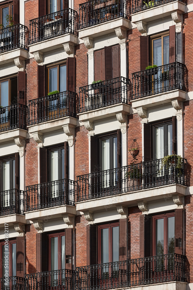 Traditional building facade. Downtown in Madrid. Red bricks. Spain