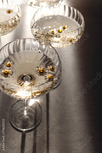 Sparkling wine with daisy flowers. Top view.