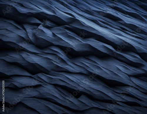 Black rock texture. Dark blue stone grunge background. Mountain close-up. Crashed. Background with space for design.