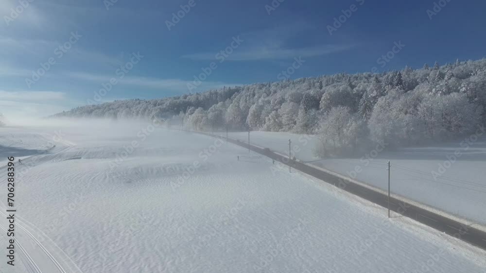 Winter landscape in fog from above and a road with cars, shot with a quadcopter. Experience breathtaking winter Switzerland from above. The footage from the quadcopter captures snow-covered views. 4k. Winter landscape in fog from above and a road with cars, shot with a quadcopter. Experience breathtaking winter Switzerland from above. The footage from the quadcopter captures snow-covered views. 4k.