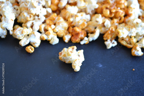 A striped bucket with flying popcorn isolated on a white background.