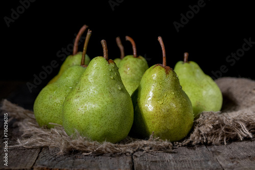 Pears on a canvas bag on a wooden table photo