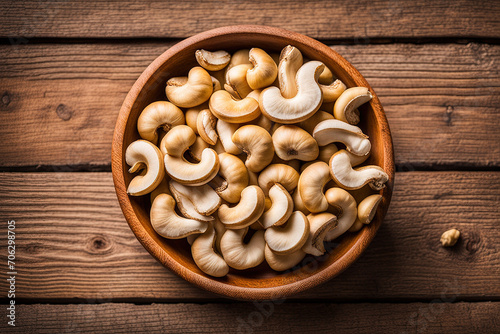 Cashew nuts on bowl top view on wodden table