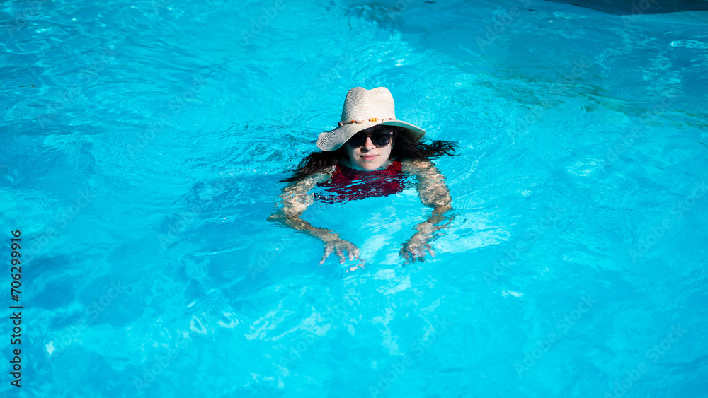 Summer portrait of a beautiful young woman inside a swimming pool