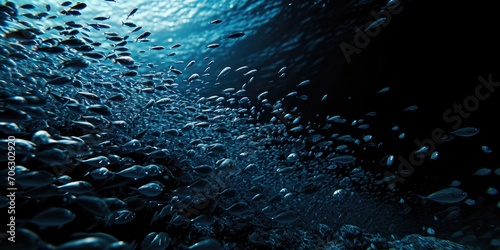 A group of fish swimming together in the vast ocean. Perfect for aquatic themes and marine life concepts